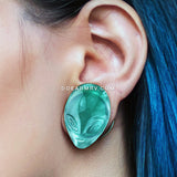 A Pair of Green Alien Head Glass Double Flare Plugs